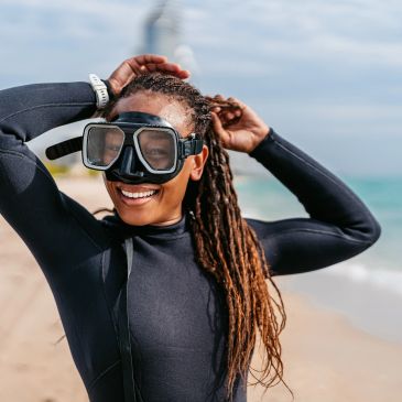 female scuba diver with a scuba mask and wetsuit