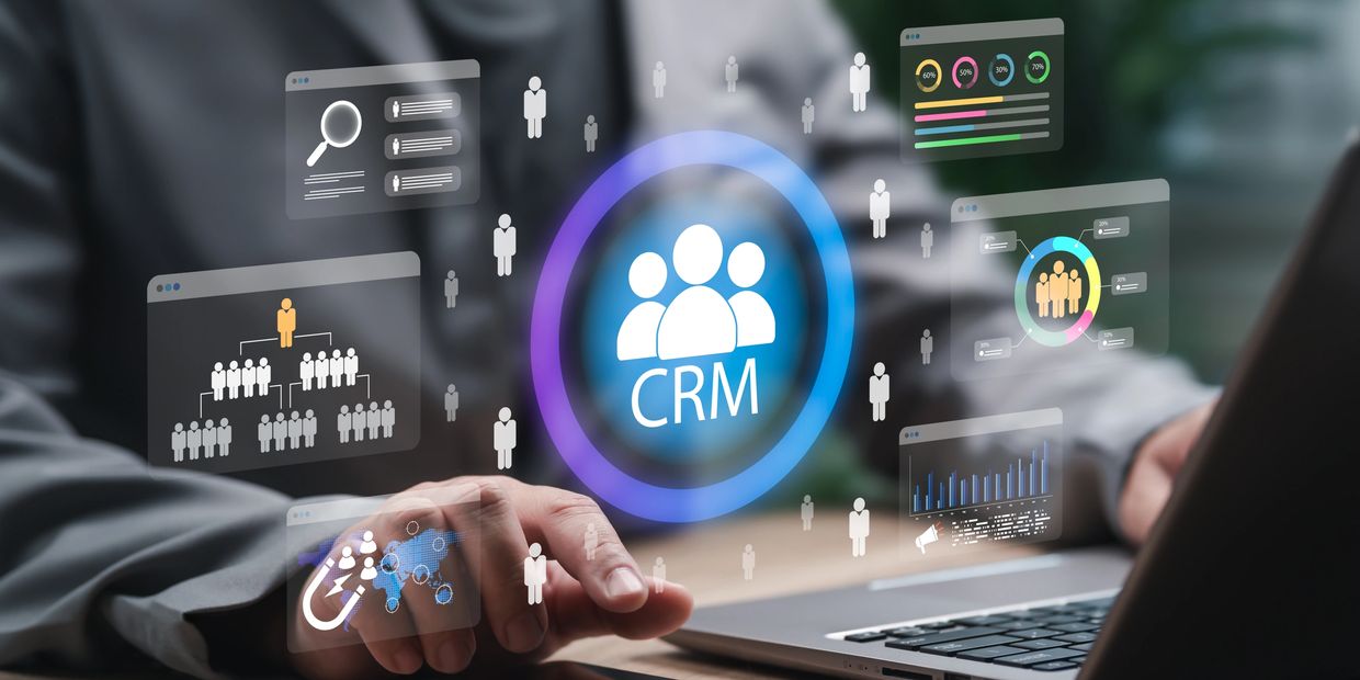 Person interacting with a digital CRM interface on a laptop.