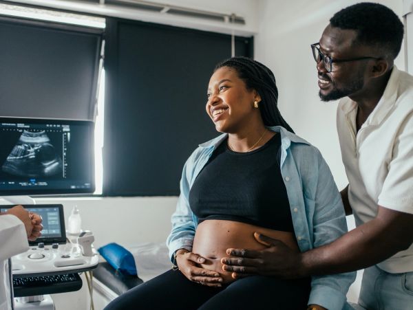 Couple excited during pregnancy ultrasound.