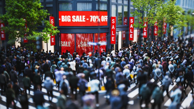 Crowd gathered in front of a store for a big sale event. CGI (all objects in the scene are 3D)