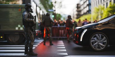 Armed police officers guarding a city street.