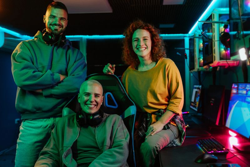 Gamers streaming online together, showing teamwork and friendship in a professional gaming setup with vibrant neon lighting