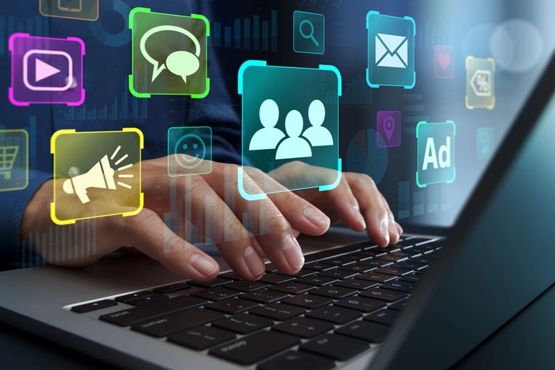 Marketer using laptop computer to analyze conversion rate.