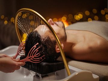 Person getting hair washed in a salon.