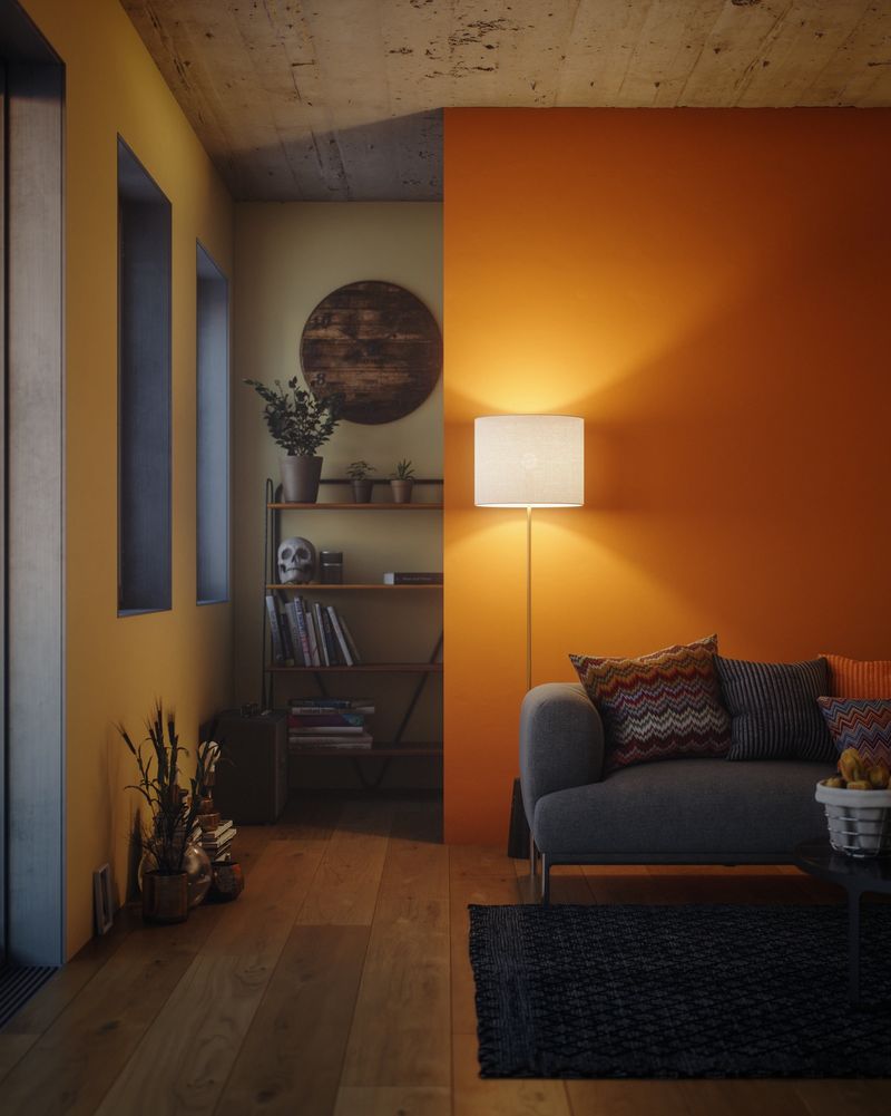 Digitally generated vertical view of a living room corner with tall windows, a bright orange feature wall and a floor lamp casting soft light over a bookshelf, plants and decorative objects. Wooden flooring and layered textures create a warm, intimate evening mood. No people.