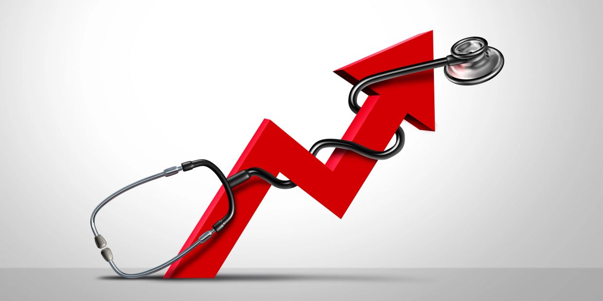 A red upward arrow entwined by a stethoscope symbolizing healthcare growth.