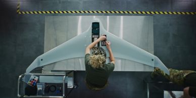 A person operates a drone in an industrial setting.