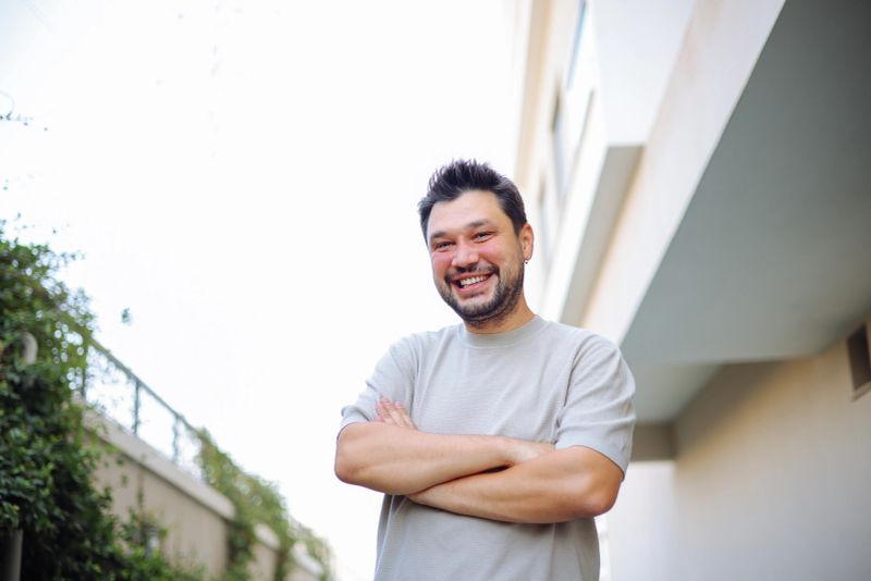 Portrait of a male fashion model smiling outdoors on a summer day