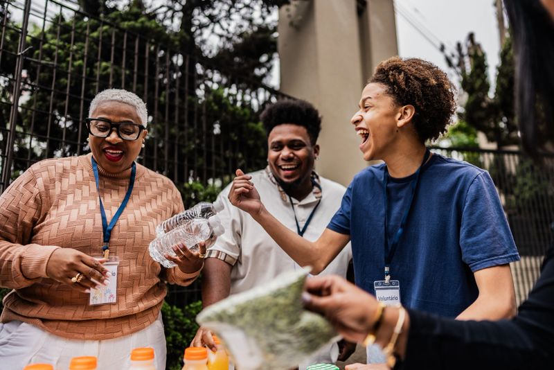 A vibrant scene of community engagement, showing a diverse group of volunteers working together to prepare and organize food donations. The image captures the spirit of teamwork, social responsibility, and collective effort in supporting local community needs.