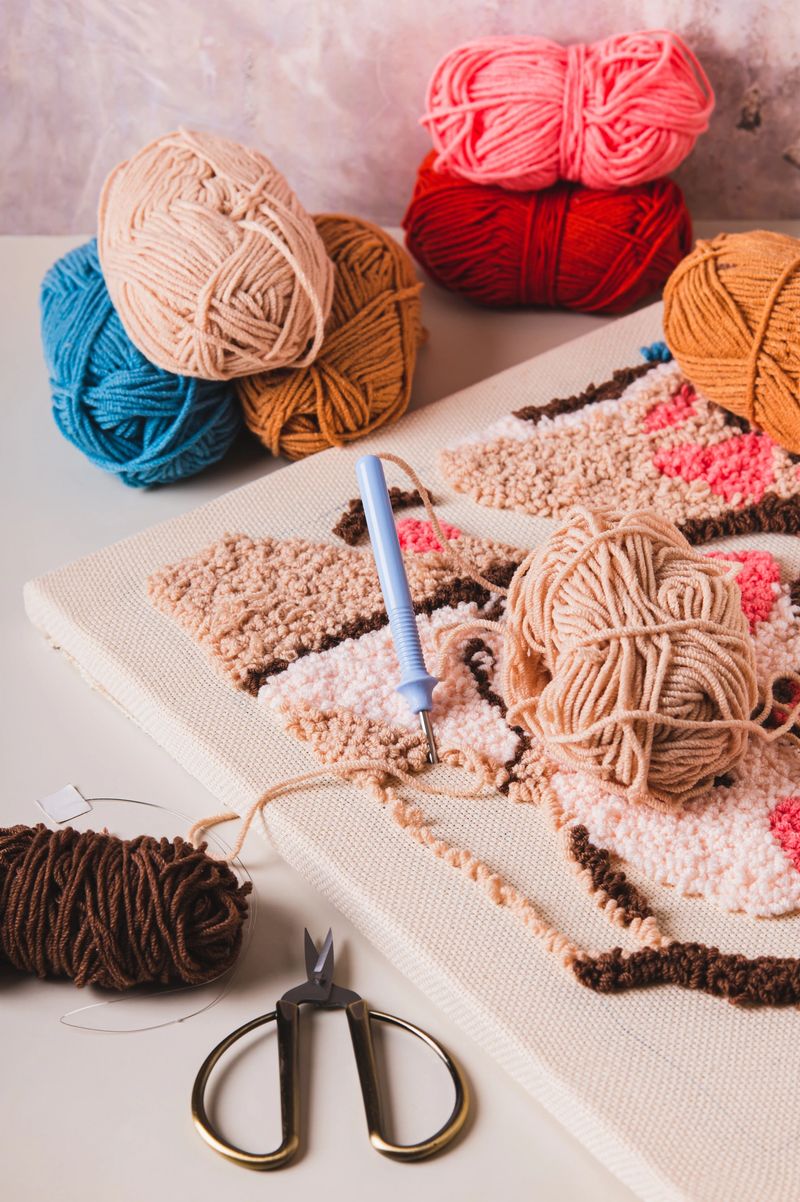 Punch needling kit, threads, canvas and needle for handmade crafts on the table vertical view