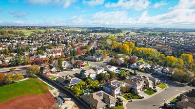Aerial view of a suburban neighborhood with houses and greenery.