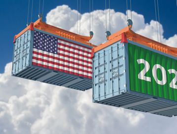 Two shipping containers with USA flag and 2026 hanging in the sky.
