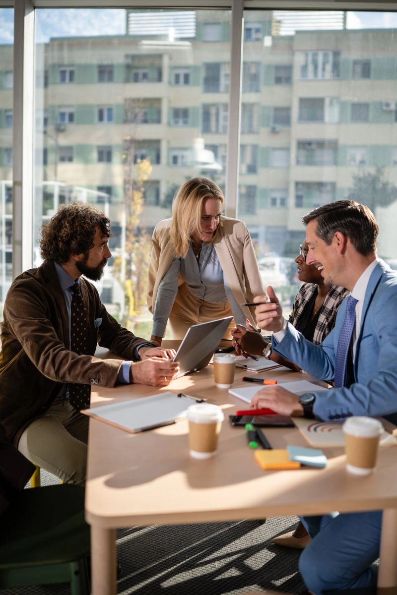 Diverse business colleagues brainstorming ideas and discussing strategy during a corporate meeting in a modern office