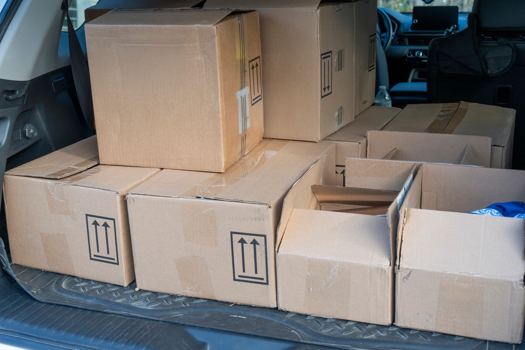 A photo of a SUv with packages in the trunk.