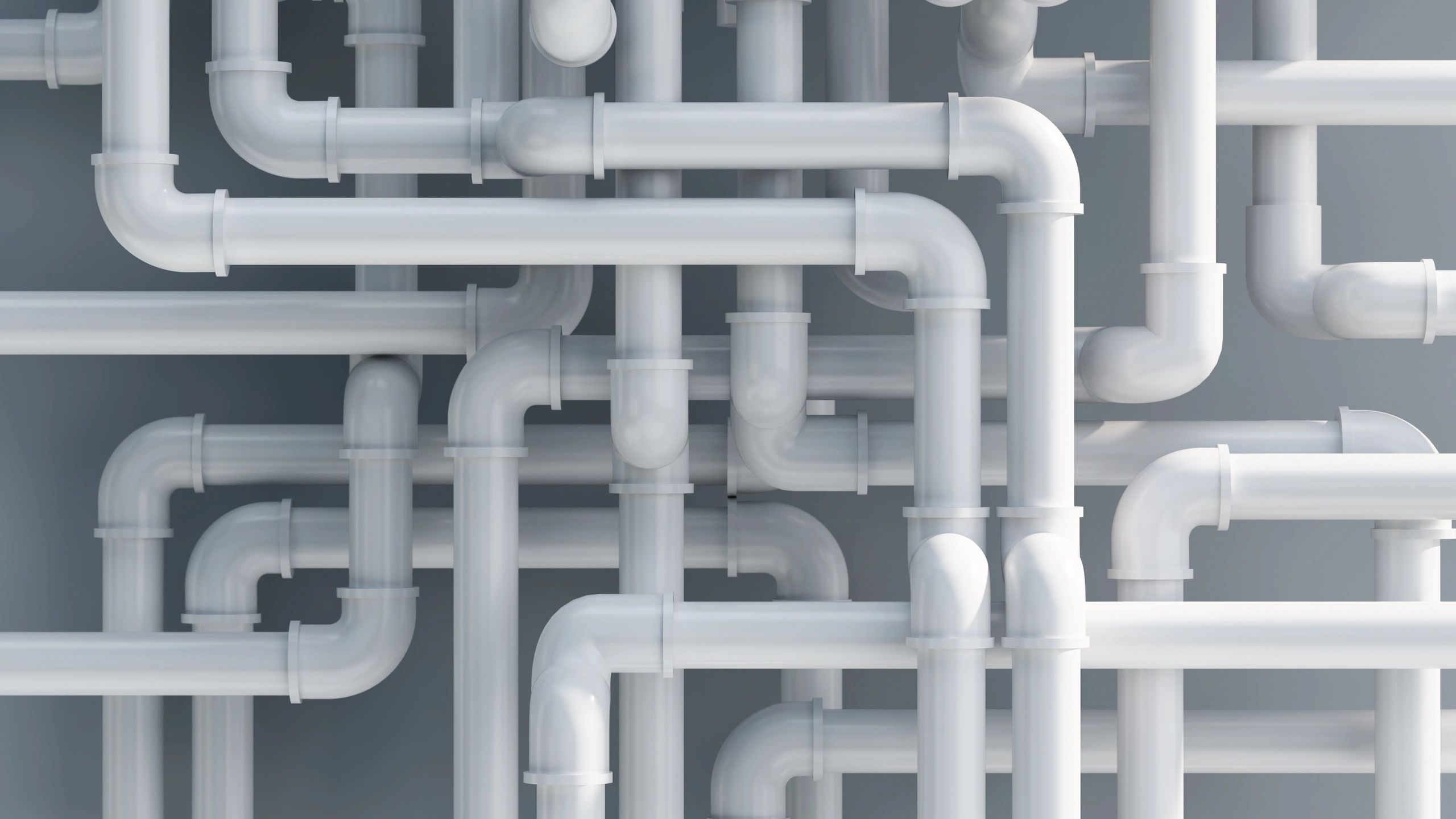 Complex network of interconnected white pipes.