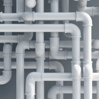 Tangled network of white pipes with various bends and joints.