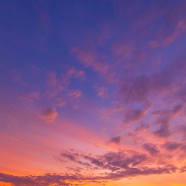 Vibrant sunset sky with purple, pink, and orange hues.