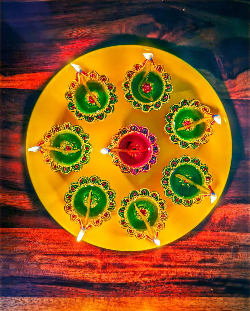 Close up image of colorful Deepavali diya's lit in a plate for Diwali festival celebration