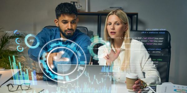 Two professionals analyzing futuristic data visualizations.