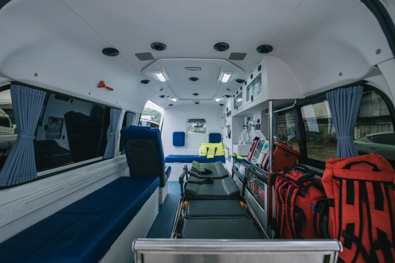 Interior of a modern ambulance showing stretcher, emergency bags, medical cabinets, and equipment prepared for healthcare and emergency response. Bangkok