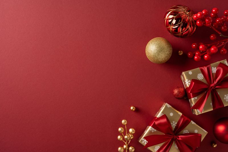 Vibrant red gifts with gold wrapping, ribbons, and seasonal ornaments against a deep red backdrop, capturing Christmas and New Year celebration mood and the beauty of gift giving and festive decor
