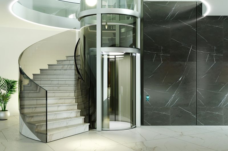 Elegant, contemporary interior with a cylindrical glass elevator and a stunning spiral staircase, set against a polished marble backdrop.3d illustration
