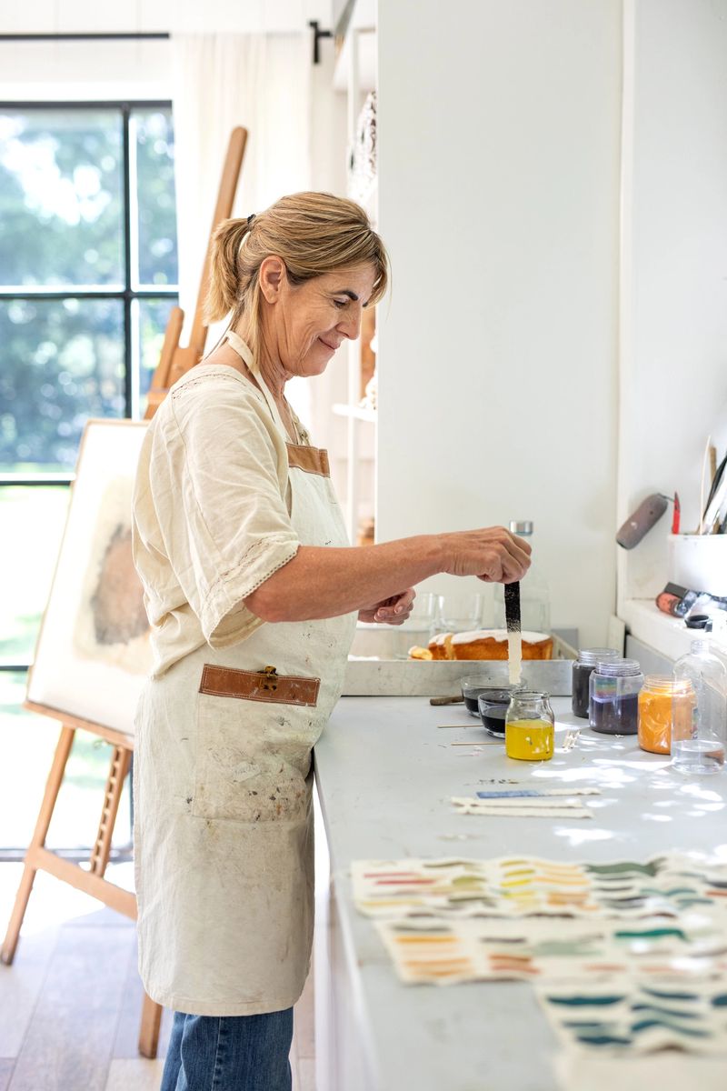 Female artist painting with dye samples of colors on canvas - Buenos Aires - Argentina