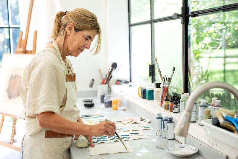 Female artist painting with dye samples of colors on canvas - Buenos Aires - Argentina