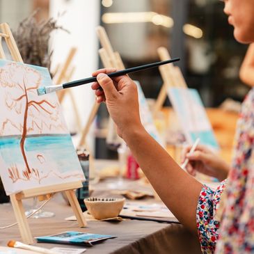 A scenic landscape featuring mountains, a lake, and a clear blue sky.