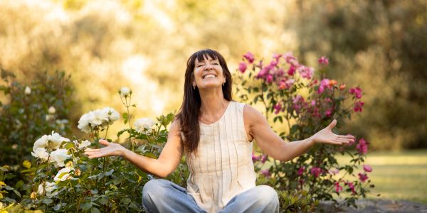 Woman enjoying nature among flowers.