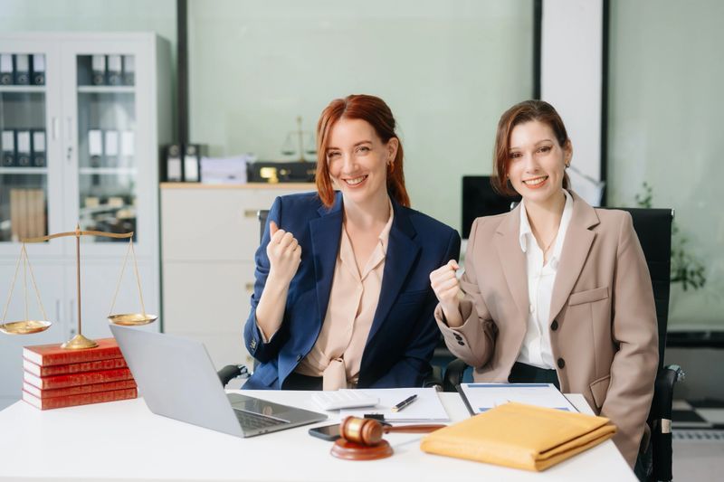 Professional female lawyers consulting on legal cases in a modern office. Perfect for law, business, justice, and teamwork concepts.
