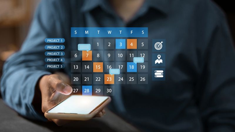 Person using smartphone to manage project schedule on smart calendar app. Concept of productivity, planning, and workflow organization.