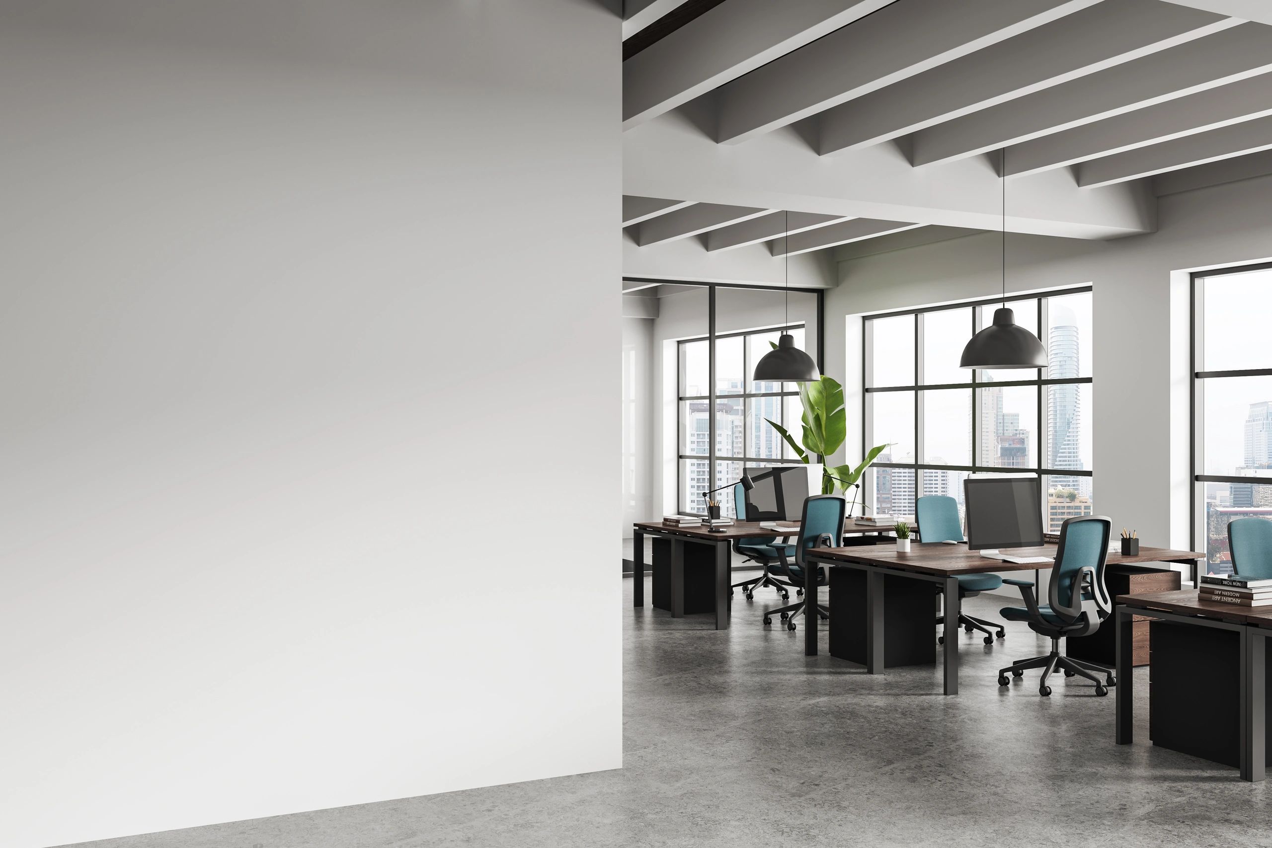Modern open office space with desks, chairs, and large windows overlooking a cityscape.