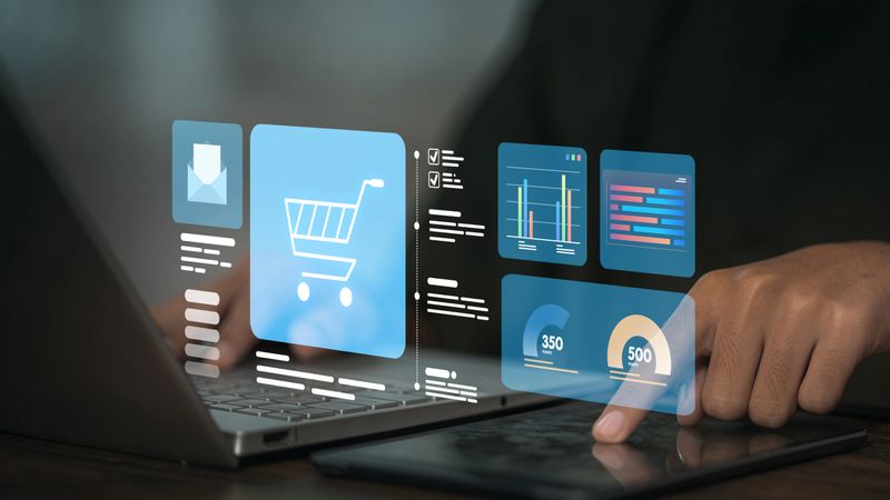 Digital dashboard showing shopping cart, email marketing, and analytics on laptop and tablet. Concept of e-commerce strategy and data-driven marketing.