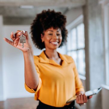 Smiling woman holding house keys.