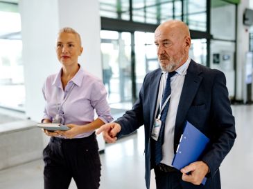 Two professionals walking and discussing.