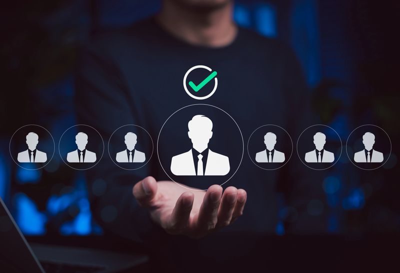 Human resource selection concept. HR professional holding an icon of chosen candidate, representing recruitment, employee hiring, job interview and business talent acquisition strategy.