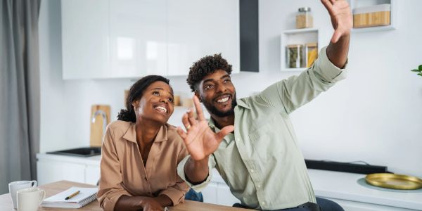 Couple happily taking a selfie in the kitchen.