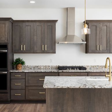 Modern kitchen with wooden cabinets and granite countertops.