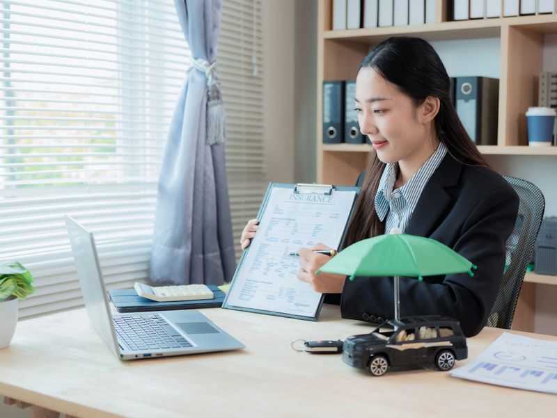 Protecting cars, automobiles, concepts of car insurance and collision exclusions, sales representatives negotiating loan agreements and signing contracts.