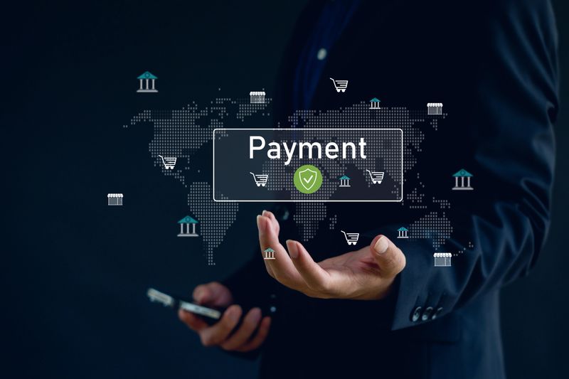 business person holding a digital payment icon with global financial symbols, representing secure online transactions, fintech solutions, e-commerce payments, and international digital banking.