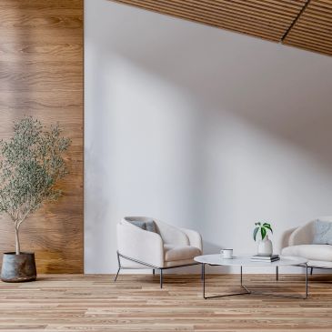 Minimalist living room with white chairs and wooden accents.