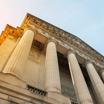 Upward view of neoclassical building columns.