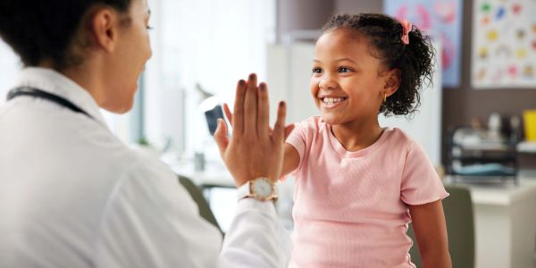 Doctor and child giving a high five.
