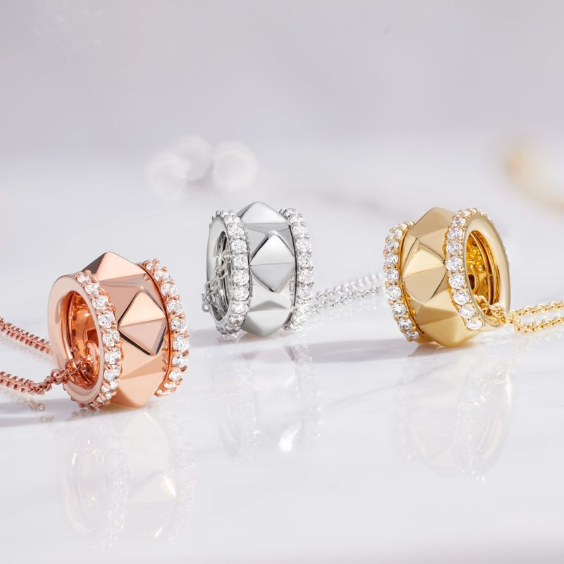 Elegant crystal-studded circular rings with geometric facets in rose gold, silver, and gold tones. Arranged on a reflective surface, these chic jewelry pieces convey luxury, fashion, and refined sophistication for stylish occasions.