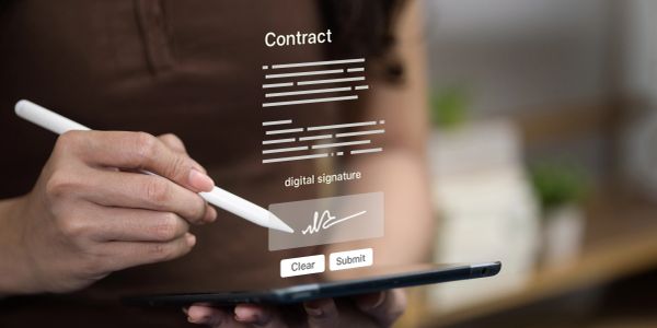 Person digitally signing a contract on a tablet.
