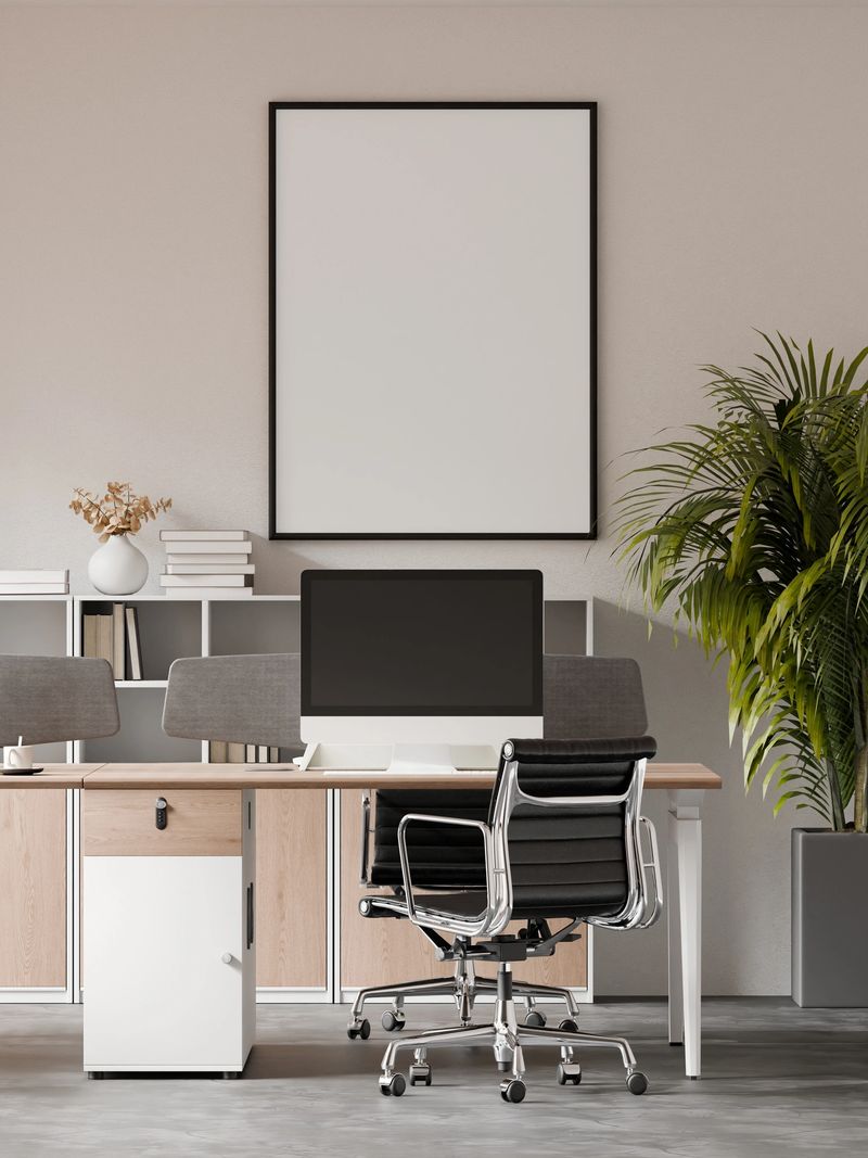 Modern open office workspace interior featuring a clean frame poster mockup on the wall. Contemporary corporate office design with minimal style, copy space, and realistic 3D render suitable for branding, presentation, and interior visualization.