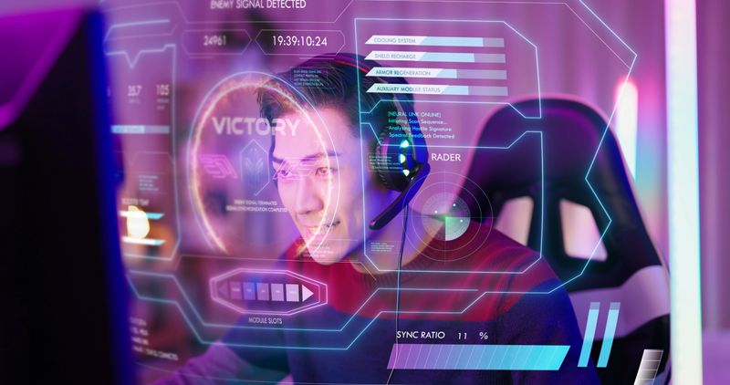an asian Gen Z male gamer celebrates a win while using a futuristic virtual interface in neon-lit room