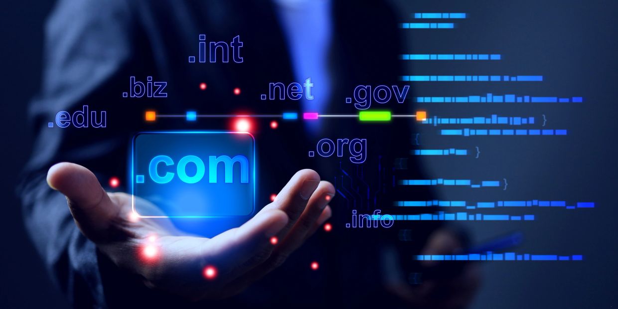 Hand holding glowing domain extensions like .com, .org, and .net.