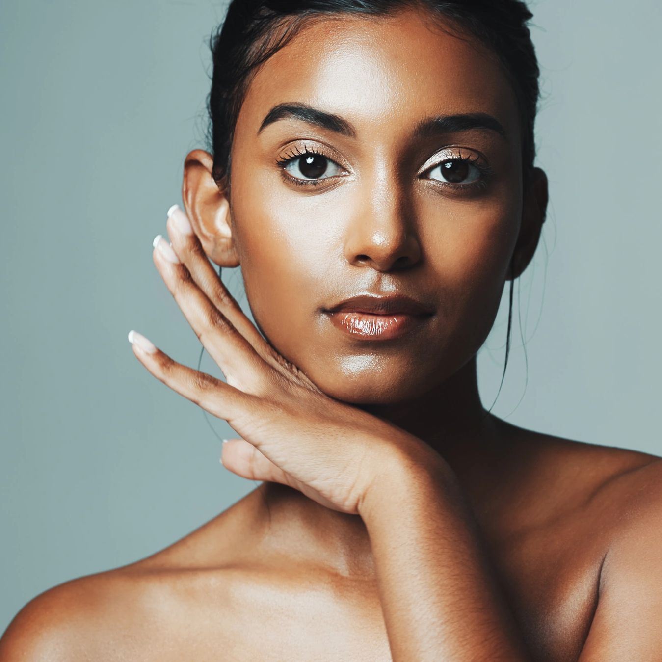 Close-up portrait of a woman with smooth skin and natural makeup.